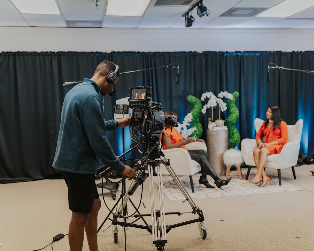 Small film crew filming an interview in a studio